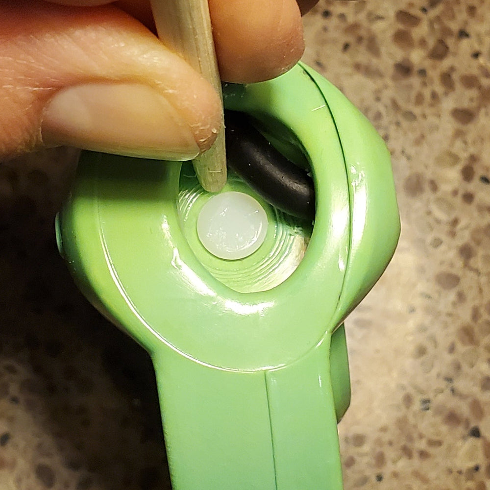 close up showing the latch pushed aside of the pin