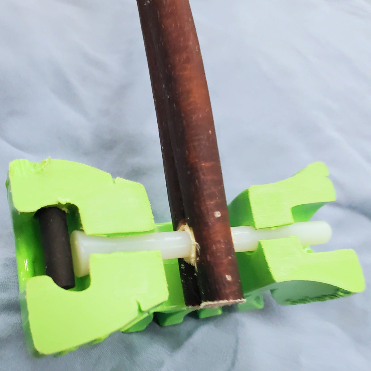 Cross-section of the SafetyChew+ locking pin securing a bully stick.